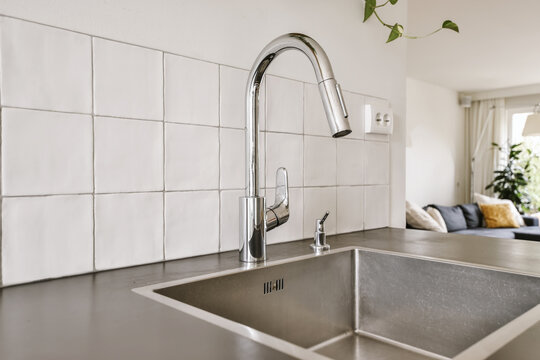 Metal tap and sink in modern kitchen