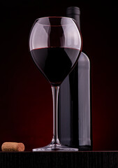glass of red wine on a red background.