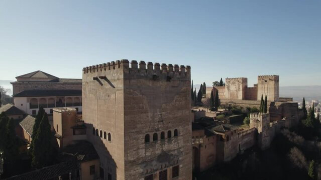 Drone flying around Comares Tower of Alhambra fortress, Granada in Spain. Aerial orbiting