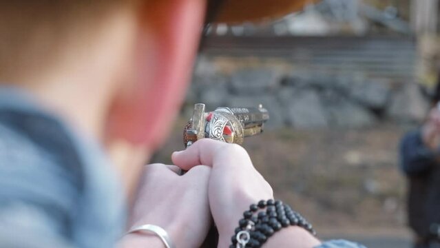 Over shoulder shot of cowboy pointing gun at cowgirl.