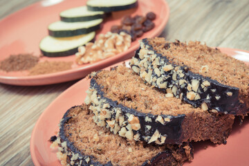 Pastry made of zucchini with nuts and raisin on wooden board. Delicious dessert