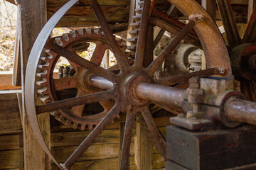 Fototapeta na wymiar old rusty gears from Falling Spring Mill in Mark Twain National Forest