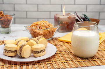 glass of milk with cornstarch alfajores nuts and cereals for a healthy breakfast or snack