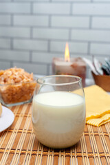 glass of milk with cornstarch alfajores nuts and cereals for a healthy breakfast or snack