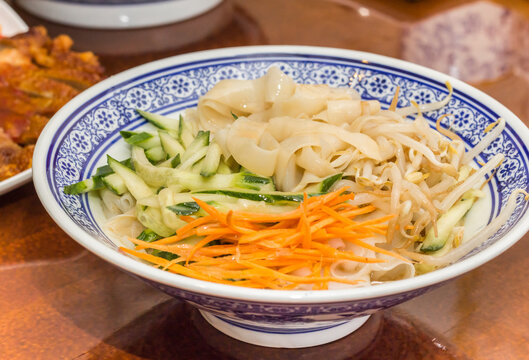 Traditional chinese cold skin noodles (Liang pi) with vegetables