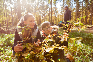 Two children identifying a tree as nature education