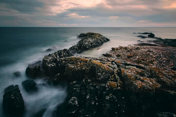 Dramatic cloudy sunset  landscape scenery of rocky coast at Seaweed beach in county Galway, Ireland 