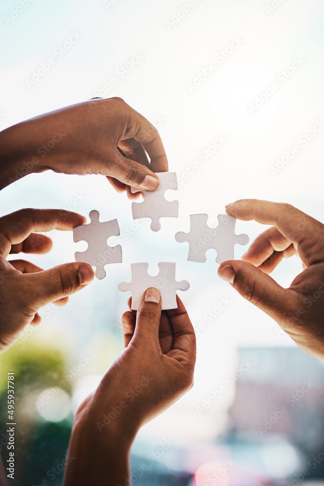 Poster every problem has a solution. cropped shot of businesspeople completing a puzzle together in a moder