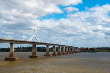 Landscape of Mukdahan Thai-Laos Friendship Bridge II viewpoint at Mekong river in cloudy blue sky background at Mukdahan province, Thailand.