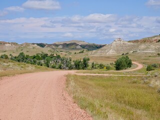 Scenic road winding through badlands in Theodore Roosevelt National Park. North Dakota, USA.