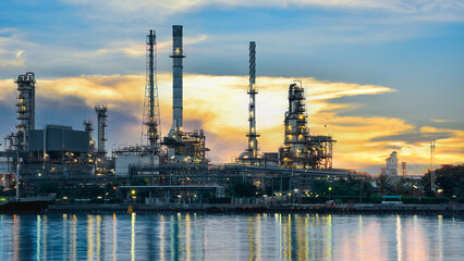 Oil and gas refinery plant area at sunrise near sea port or river