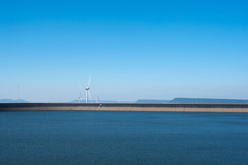 Beautiful landscape of Khao Yai Thiang reservoir with wind turbine electrical energy plant at Nakhon Ratchasima, Thailand.