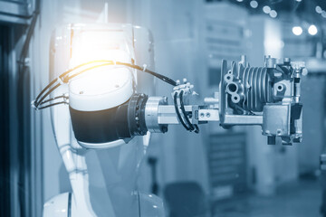 The hi-technology  material handling process by robotic system with cylinder block parts.