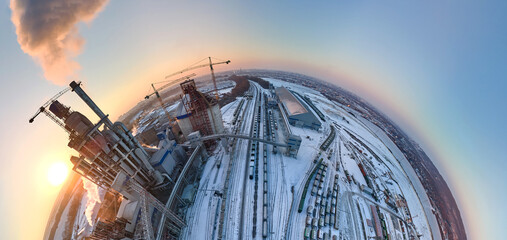 Aerial view from high altitude of little planet earth with cement factory high concrete structure...