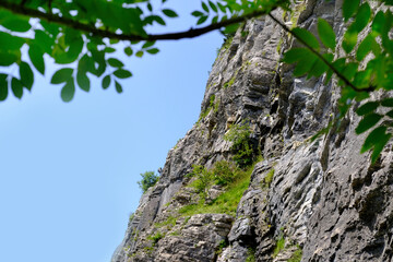 man in body harnesses feature life-safety, attaches hooks to iron brackets, climbs rock, active lifestyle of people, mountaineering, via ferrata in mountains of alps, life insurance in extreme sports