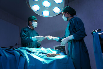 Asian Surgical Team Performing Surgery in the Hospital Operating Room
