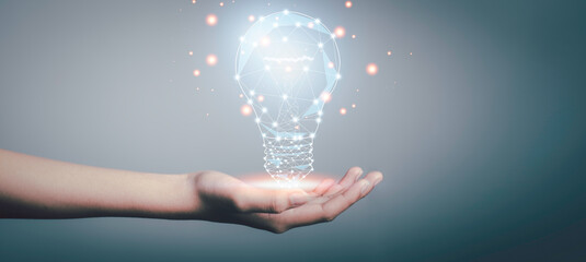 New idea and Great inspiration new beginning. concept. Hand holding digital bright light bulb  for presenting creative thinking.