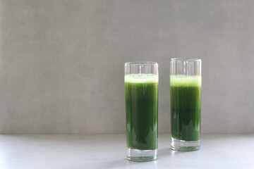 Green vegetable juice for a raw vegan diet. Fresh green from herbs and cabbage. Aojiru is a...