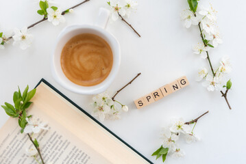Obraz na płótnie Canvas Spring morning with coffee, flowers and a book