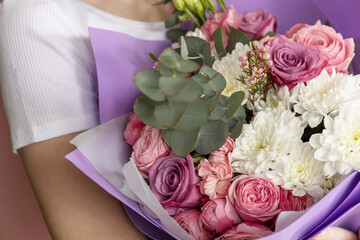 The very cute young girl's hands hold a beautiful bouquet of flowers. Concept of spring, summer nice romantic mood. Closeup.