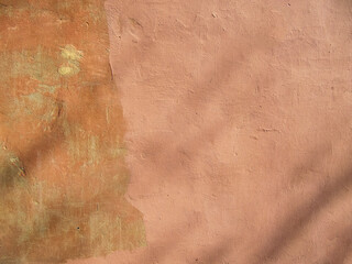 Old multi-colored  plaster  on the wall of  the building