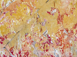 Old multi-colored plaster  on the wall of the building