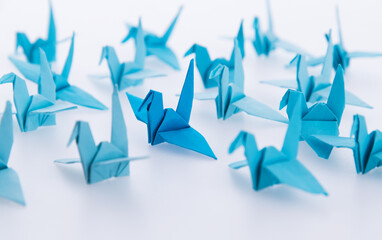 A blue origami crane stands out