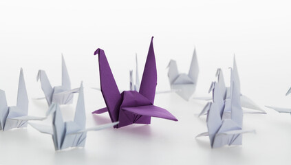 A purple origami crane stands out