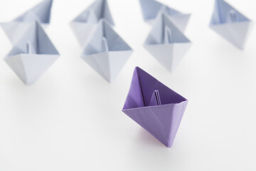 The purple origami boat is leader