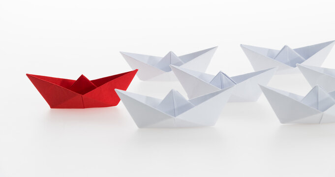 The red origami boat is leader