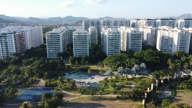 Aerial view of a park in Rio de Janeiro, Brazil. Residential buildings and mountains around. Sunny day. Drone take.