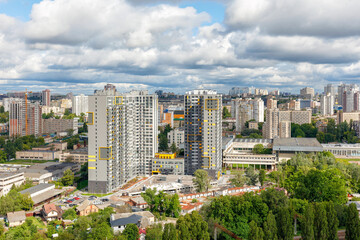 Obraz premium Cityscape from a bird's eye view with a view of the development of the old microdistrict with new high-rise residential buildings.