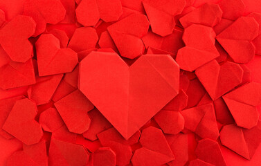 A big red origami heart on origami hearts