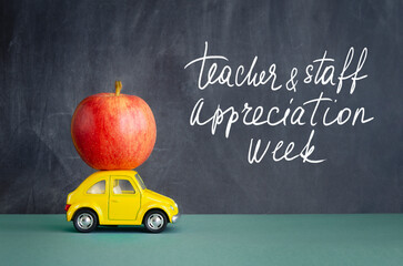 Teacher and Staff Appreciation Week school banner. White chalk lettering on black schoolboard, red...