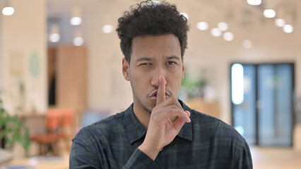 Fototapeta na wymiar African American Man showing Quiet Sign, Finger on Lips 