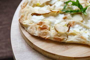 Delicious fresh Italian pizza on a round wooden table. Selective focus