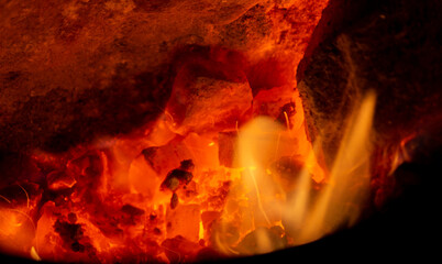 Fototapeta premium Flame coals red-hot with heat and tongues of fire