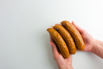 Female hands holding sausages ready to cook, fry or roast