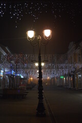 Fototapeta premium New Year's jewelry in the city on the street shines at night