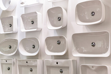 Sinks of different shapes on display in a store. Construction, repair and design.