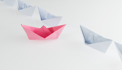 A pink origami boat stands out
