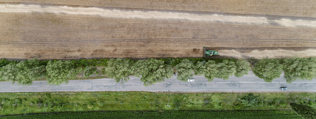 Fototapeta na wymiar Aerial view combine harvester harvesting on the field