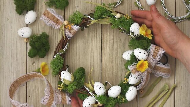 easter diy wreath with lace bow,stabilized moss,primrose flowers on a gray wooden background.copies of space, mock up.Nearby materials used. 