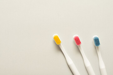 Set of toothbrushes on empty light background. Top view