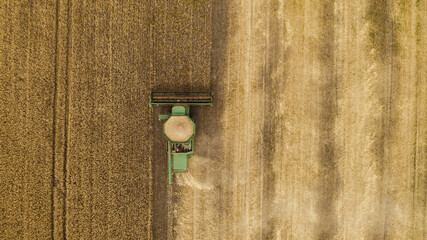 Aerial view combine harvester harvesting on the field