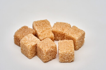 Closeup of brown sugar cubes on white