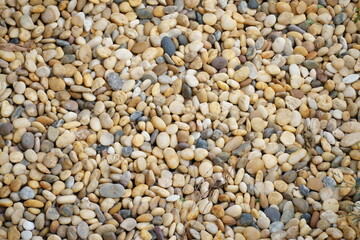 Loose pebble that is smooth and colorful by nature is from a walkway by a river bank that looks like a beach. Its peaceful Zen feelings makes perfect to use as hot stone message for relaxing muscles.