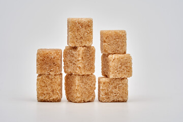 Closeup of brown sugar cubes on white