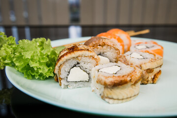 a sushi roll with eel and unagi sauce on a plate japanese cuisine
