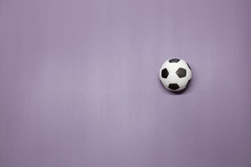Fototapeta na wymiar A soccer ball inside on a purple background